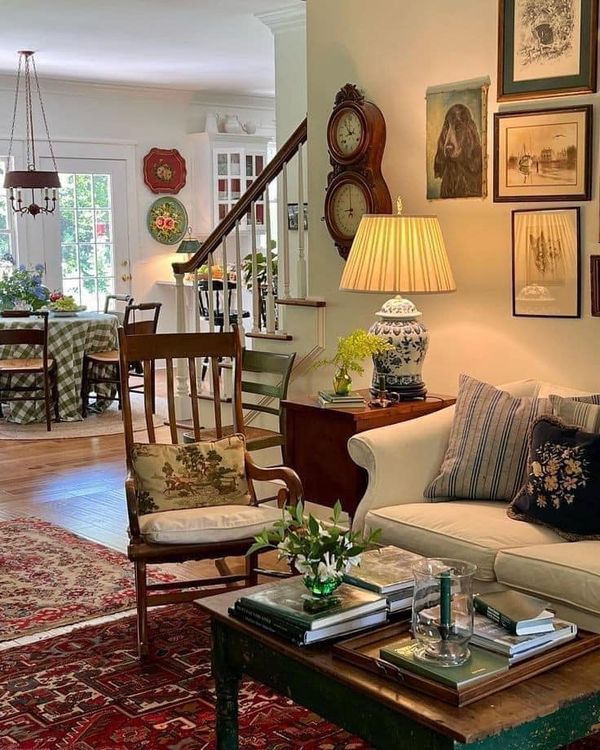 a living room filled with furniture and pictures on the wall