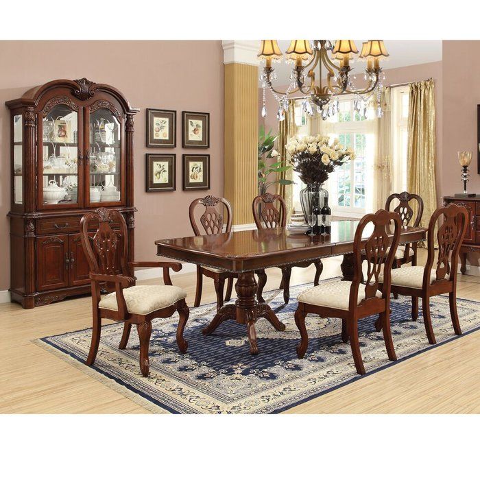 a dining room table with chairs and a chandelier