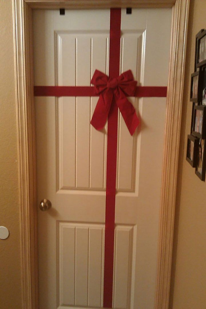 a white door with a red bow on it