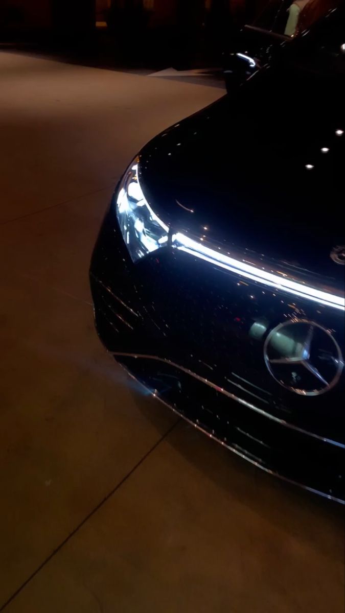 the front end of a black mercedes car