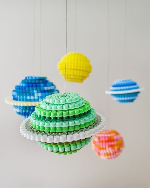 multicolored objects hanging from strings in a room