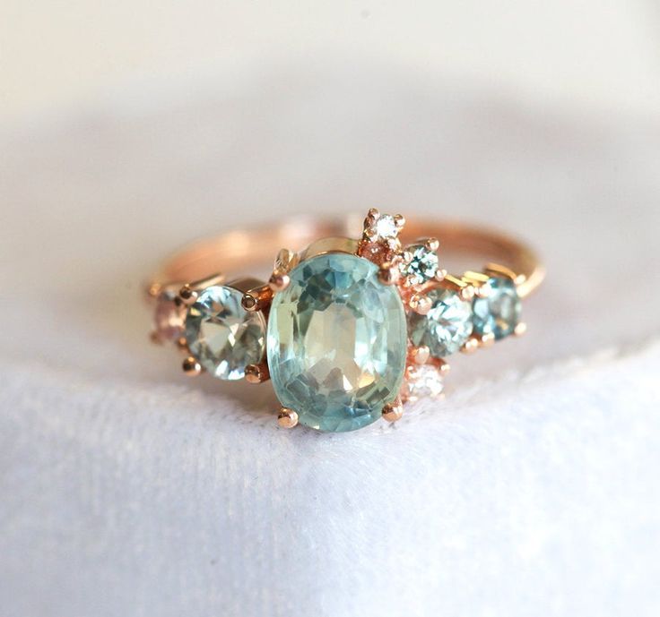 three stone ring sitting on top of a white cloth