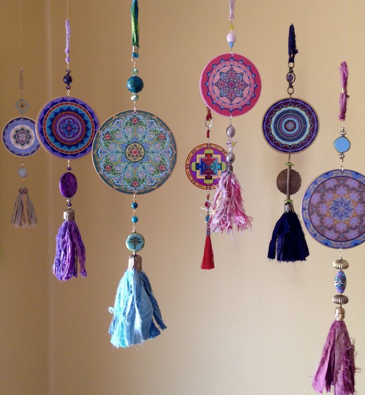 a group of different colored tassels hanging from a wall