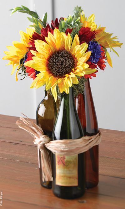 a vase filled with flowers sitting on top of a wooden table