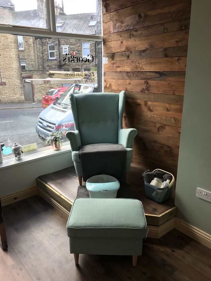 a chair and ottoman in front of a window