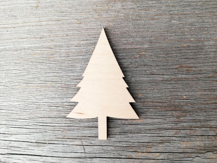 a wooden christmas tree on a table