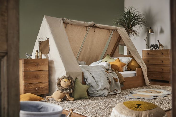 a child's bedroom with a teepee tent and stuffed animals