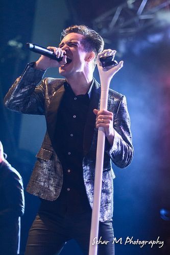 a man holding a microphone on top of a stage