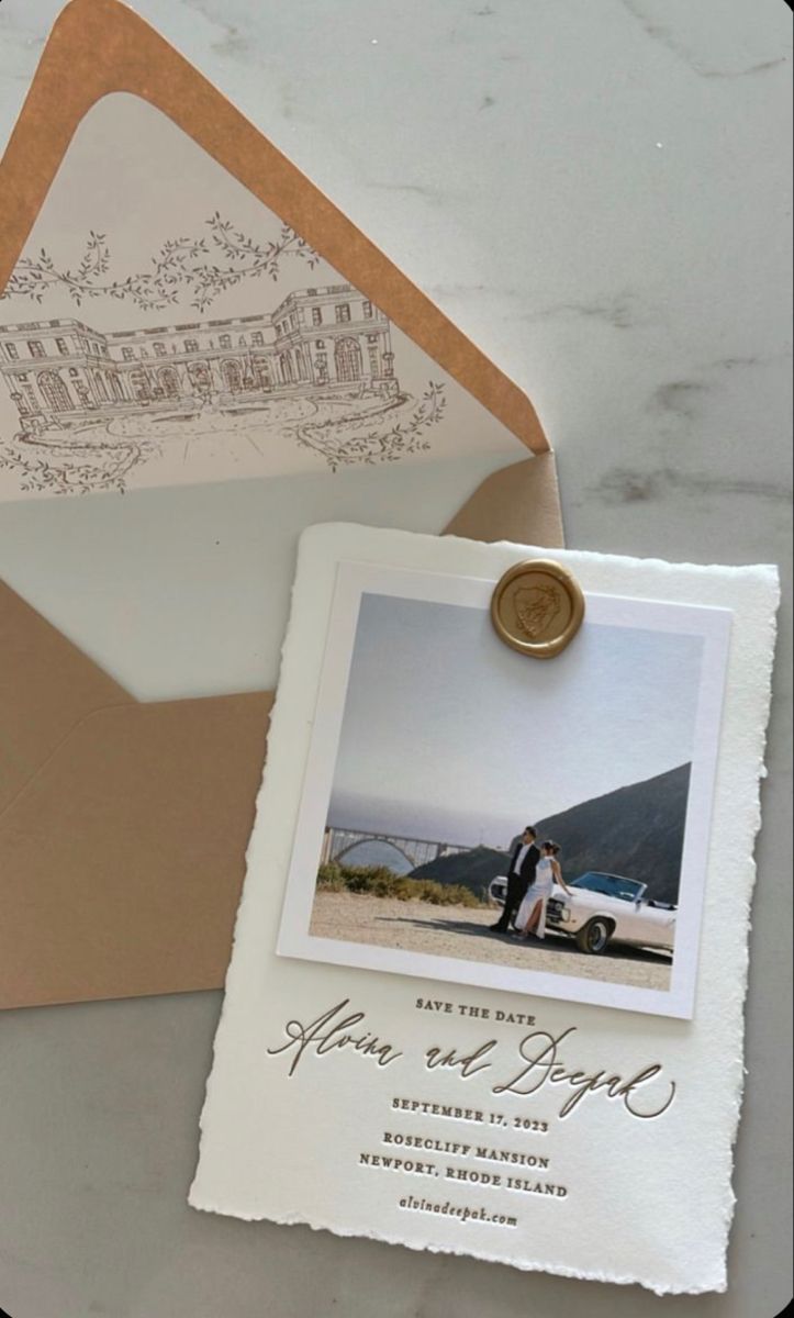 an envelope with a wedding photo on it and a wax stamp attached to the front