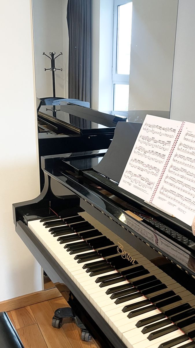 a piano with sheet music sitting on top of it