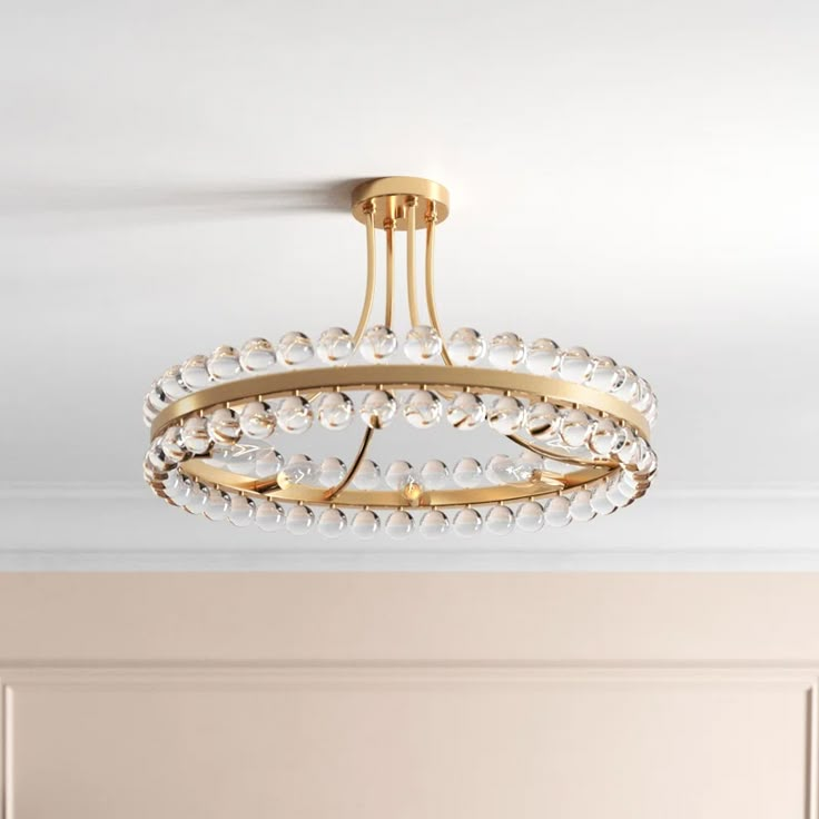 a chandelier hanging from the ceiling in a room with beige walls and white carpet