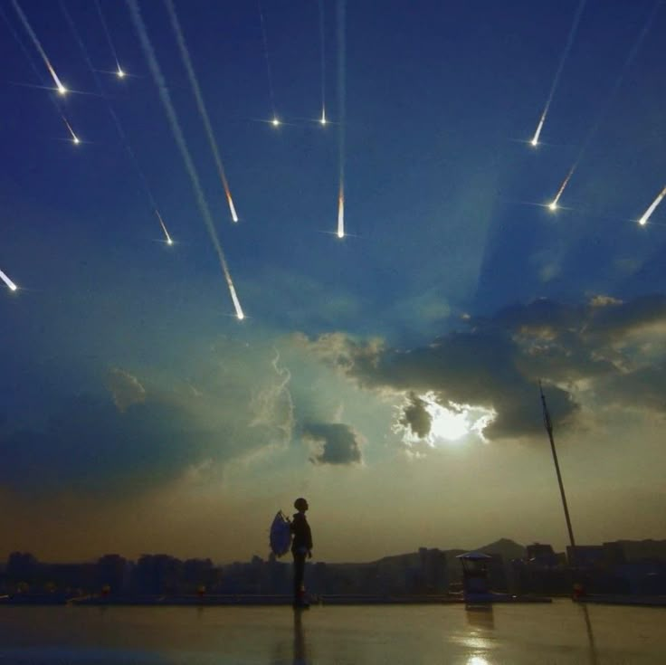 a man standing on top of a roof under a sky filled with stars and jets