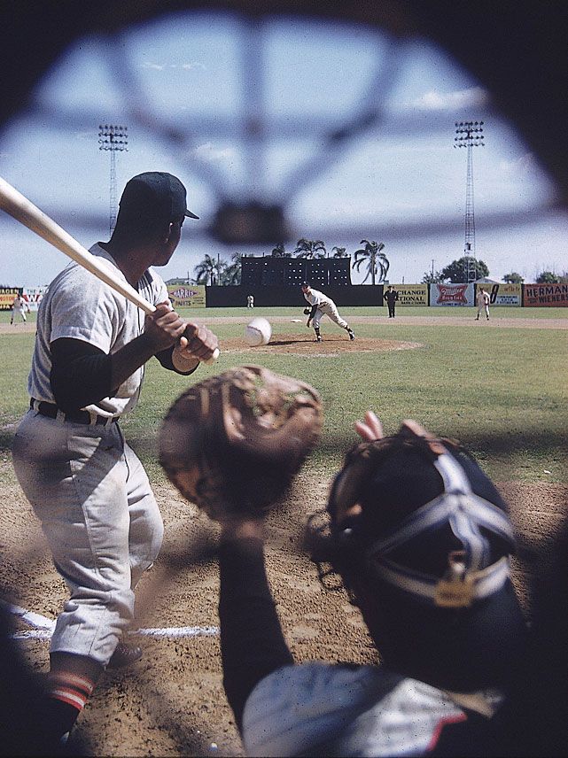 a baseball player is getting ready to hit the ball with his bat and catcher behind him