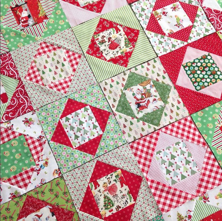 a red and green patchwork quilt with lots of different designs on the top half