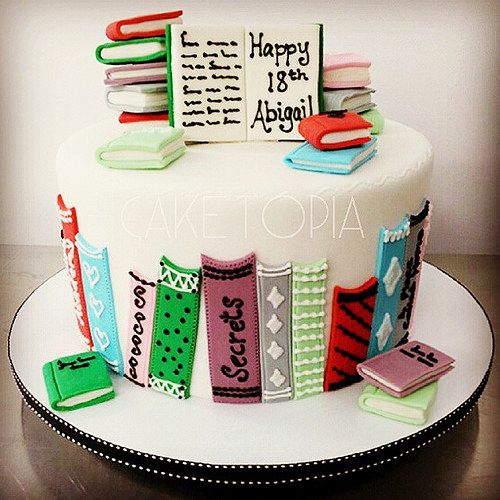 a cake decorated with books and magnets