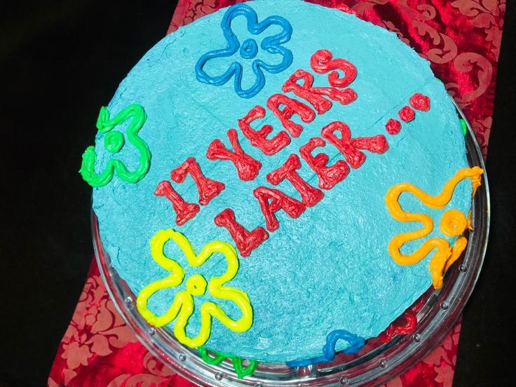 a birthday cake with the words happy new year written on it and flowers in blue frosting