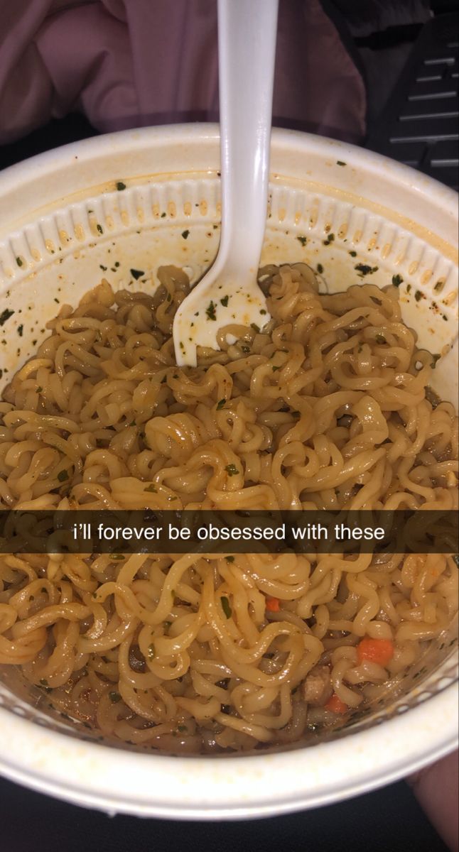 a white bowl filled with noodles on top of a table