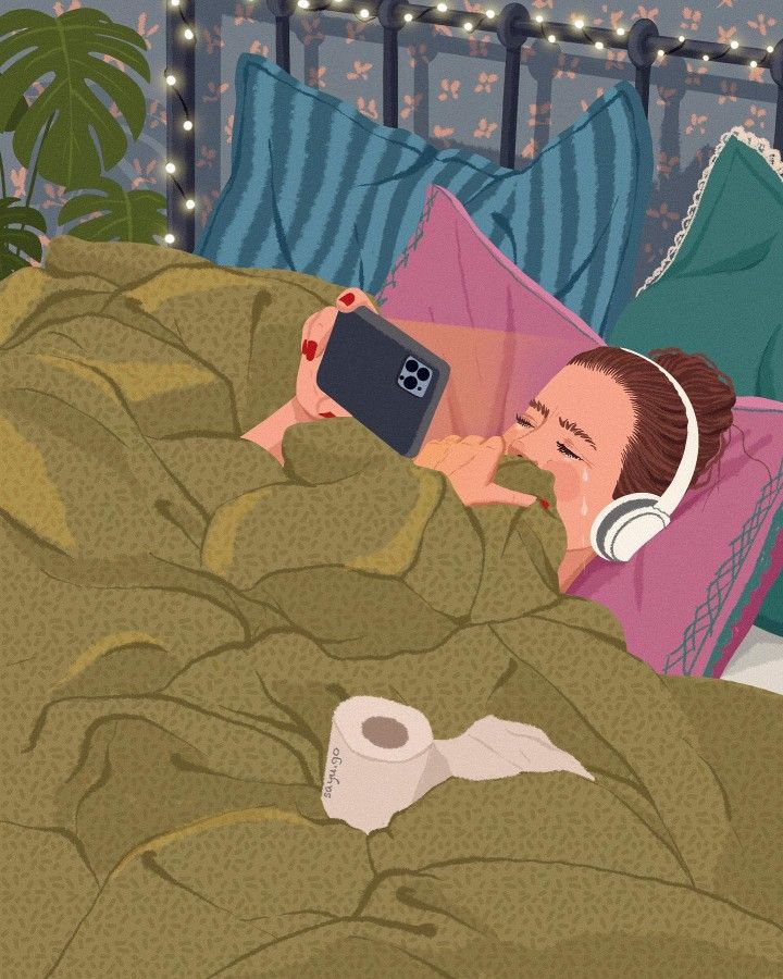 a woman laying in bed with headphones on and holding a cell phone to her ear