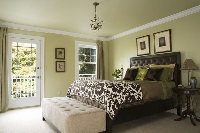 a bedroom with a large bed and pictures on the wall