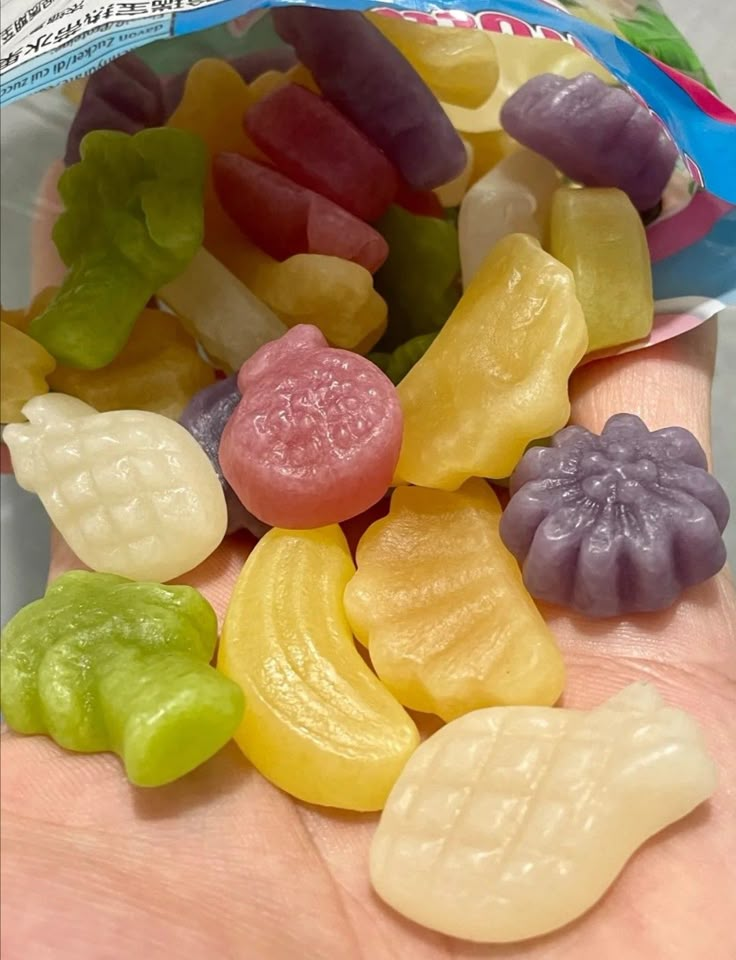 small gummy bears are in the palm of someone's hand