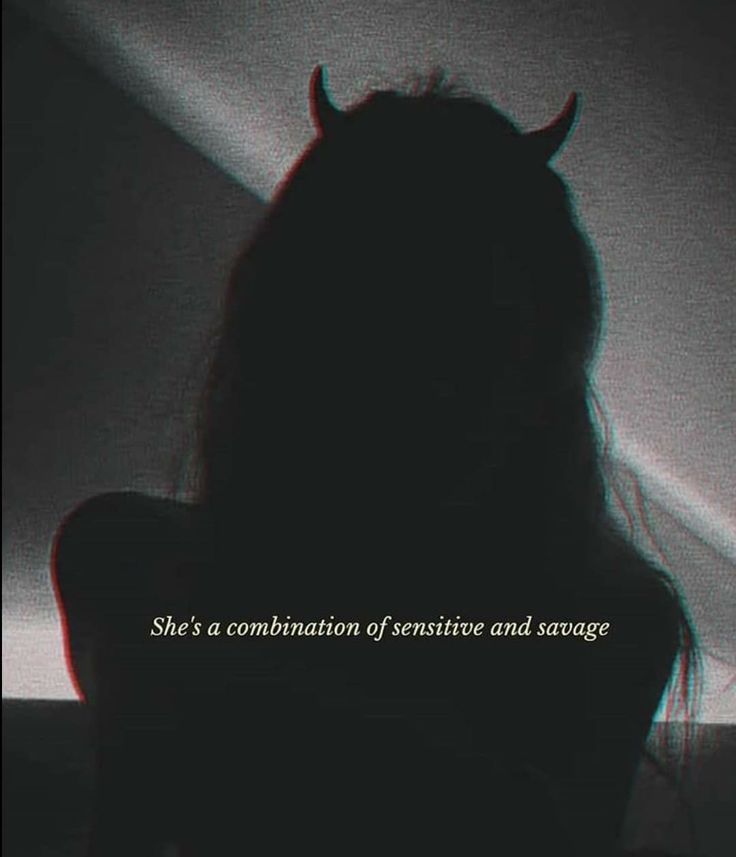 the silhouette of a woman with long hair and horns on her head is shown against a dark background