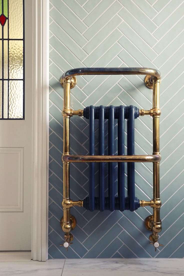 a gold and blue radiator next to a white door