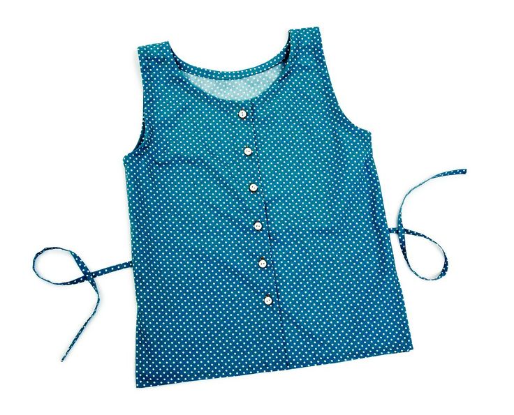 a women's blouse with blue and white polka dots on the front, tied up