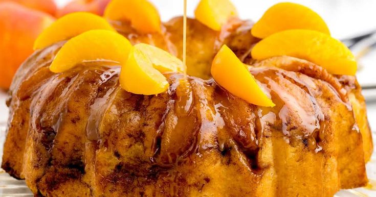 a bundt cake with icing and oranges on top