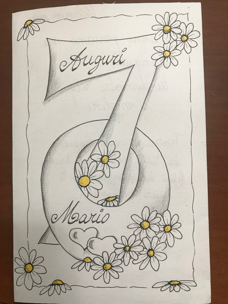 a drawing of the number seven with daisies and daisies around it on a piece of paper