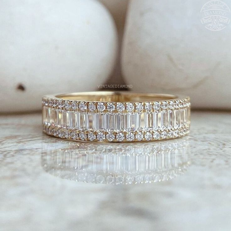 an image of a wedding band with baguettes on the side and diamonds in the middle