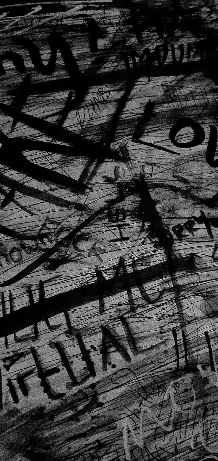 black and white photograph of graffiti on wood