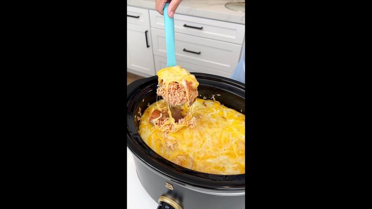 a person is lifting food out of the crock pot