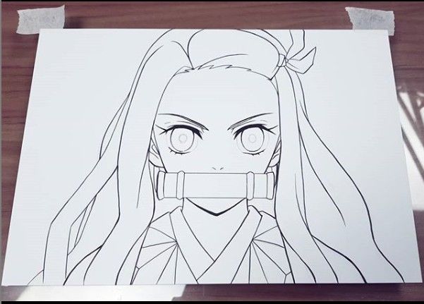 a drawing of a girl with long hair and big eyes on a piece of paper