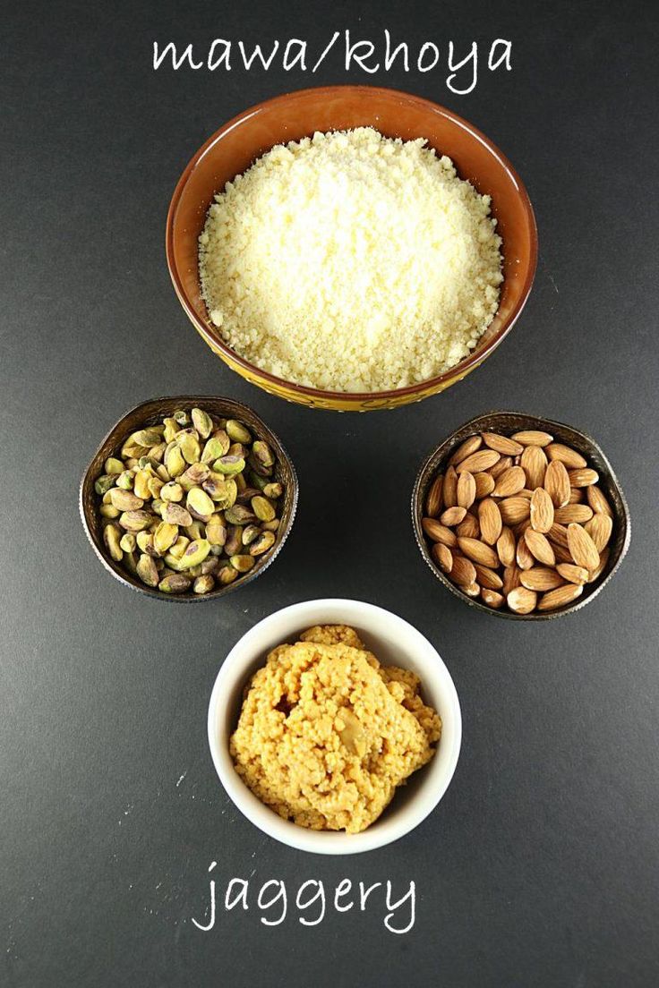 three bowls filled with different types of food on top of a black table next to each other