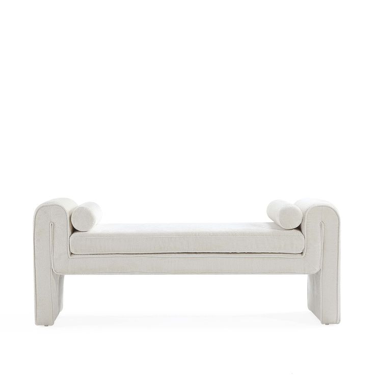 a white bench sitting on top of a white floor