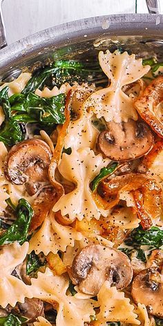 pasta with mushrooms and spinach in a skillet