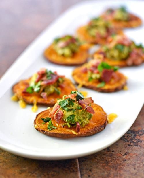 small appetizers are arranged on a white platter, ready to be eaten