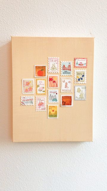 a wall mounted on the side of a white wall with many stamps attached to it