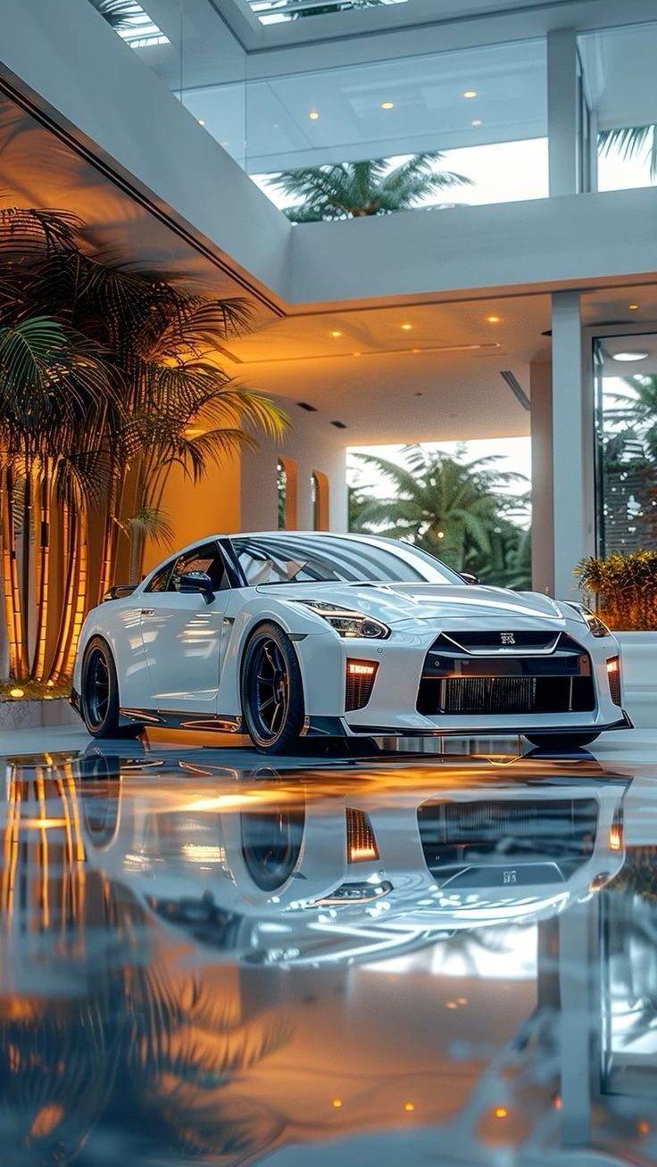 a white sports car parked in front of a large building with palm trees on the other side