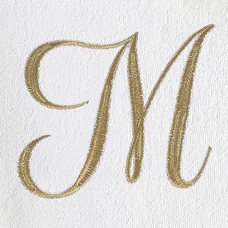 the letter m is made up of gold thread and sequins on white paper