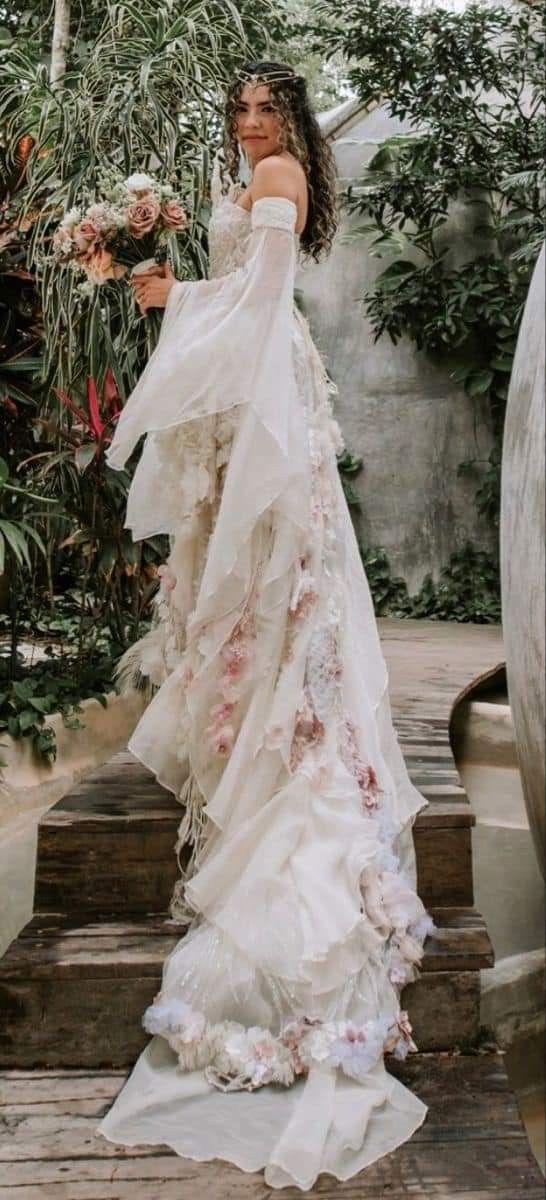 a woman in a wedding dress standing on some steps