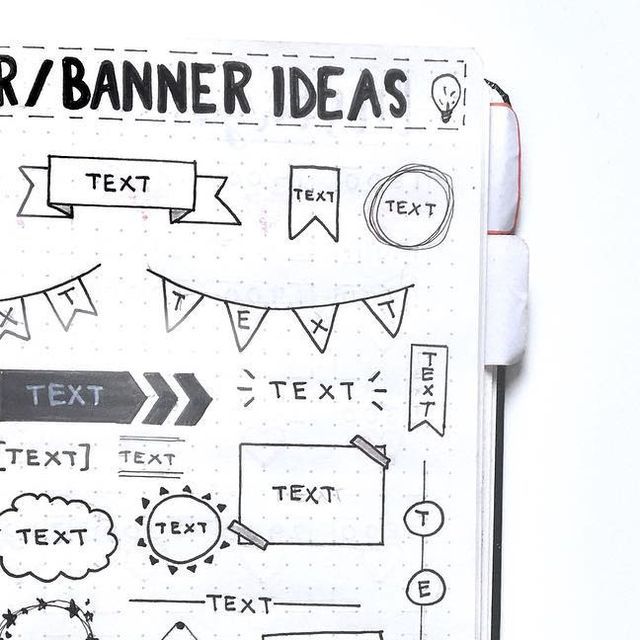 an open notebook with hand drawn text and banner ideas on it, next to a pen