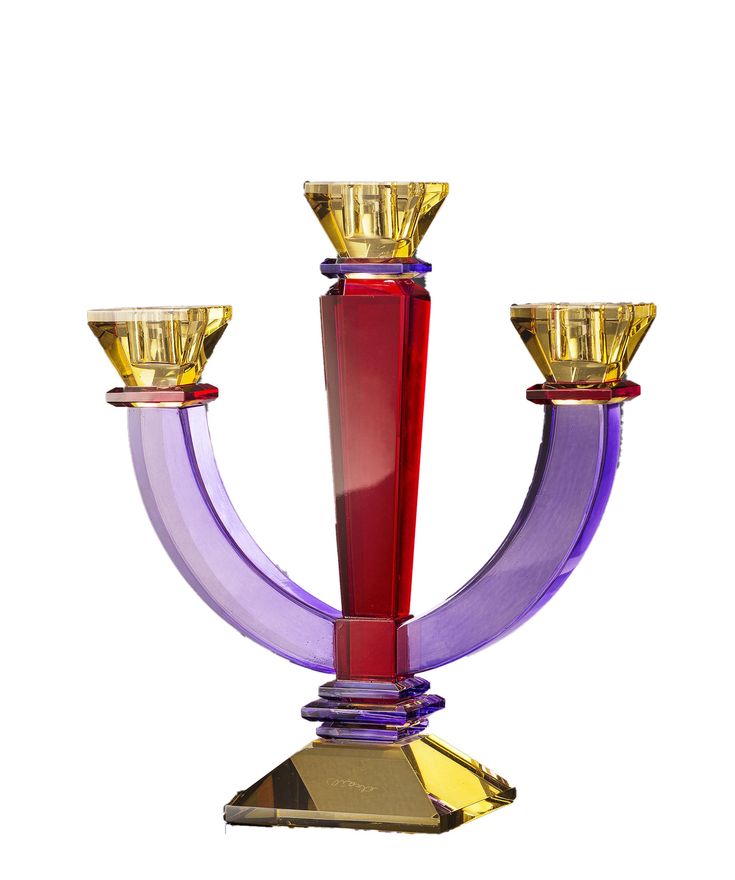 a purple and red candle holder with two candles on it's sides, against a white background