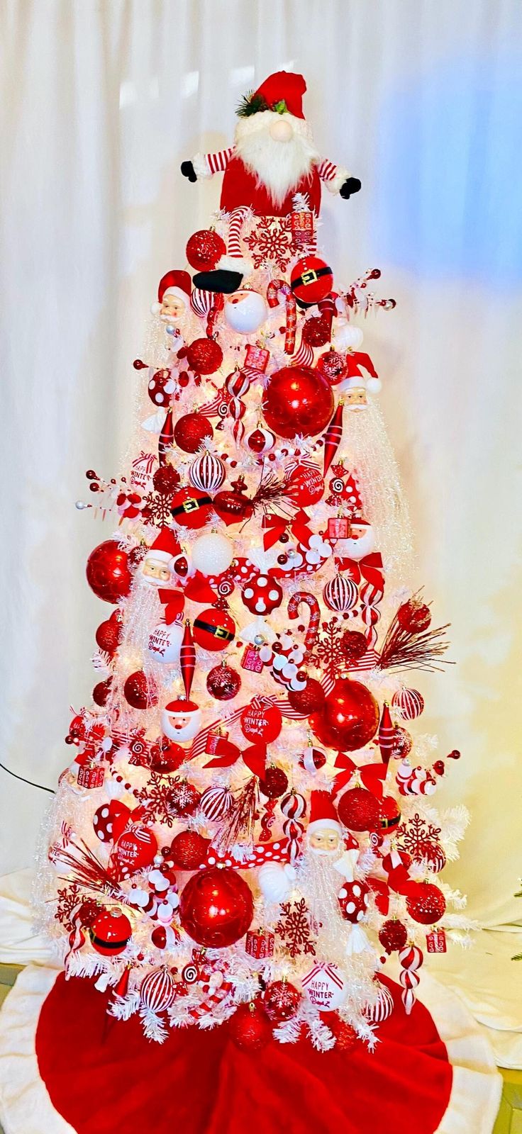 a red and white christmas tree with ornaments