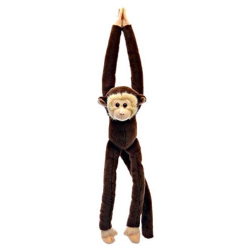 a stuffed monkey hanging from the ceiling with its hands in the air and it's eyes closed