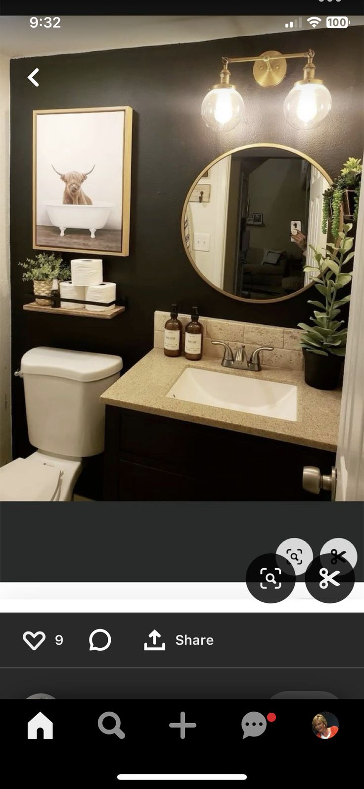 the bathroom is decorated in black and white, with gold accents on the mirror above the sink