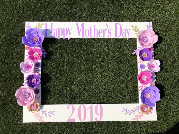 a mother's day photo frame with flowers on the grass in front of it