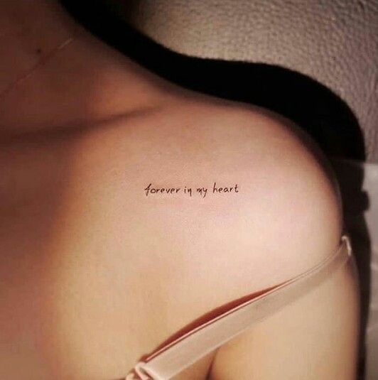 a woman's back with the words forever is my heart written on it