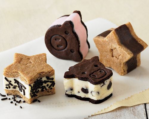 four desserts are arranged on a white plate