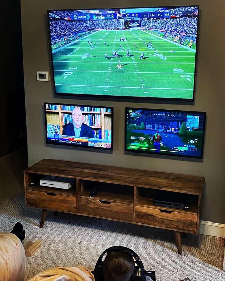 TV wall, Xbox, PlayStation, game room ideas, big Joe bean bags Man Cave Multiple Tv Set Up, Multi Tv Game Room, Xbox Tv Setup, Man Cave Multiple Tvs, Double Tv Game Room, 2 Tvs In Game Room, Family Video Game Room, Two Tv Game Room, Sports Game Room Ideas